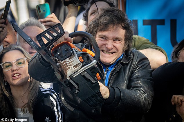 Javier Milei won the Argentine presidential election with 56% of the vote in November with some unorthodox tactics.  Pictured holding a chainsaw at one of his rallies.