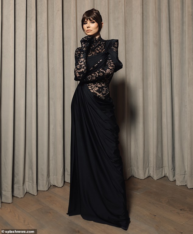 Cheryl, 40, cut a glamorous figure in a semi-sheer black dress, with elegant long lace sleeves that hid her hands.