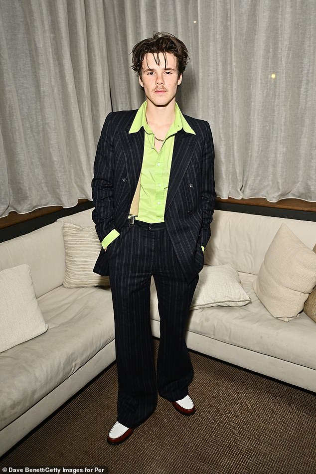 David and Victoria Beckham's youngest son, Cruz, who turned 19 yesterday, wore a striking lime green shirt with a pinstripe suit.