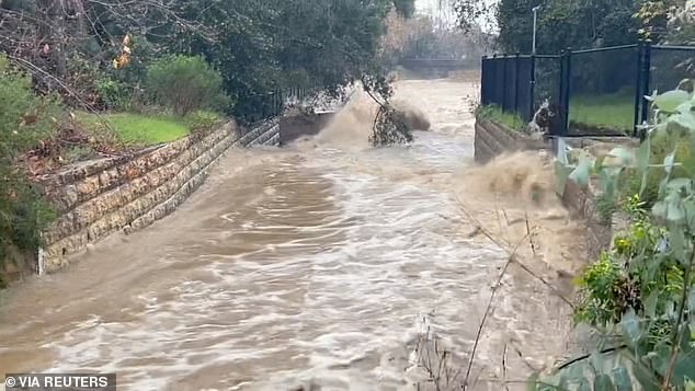 Major damage is still possible as heavy rain is forecast to inundate the Golden State through Wednesday. In the photo: flood water rushes into Montecitio