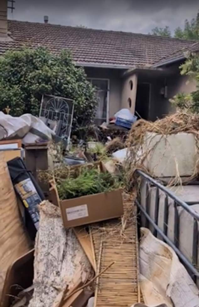 The woman claims the trash pile (pictured) is full of rats the size of her toy poodle and poses a serious fire hazard.