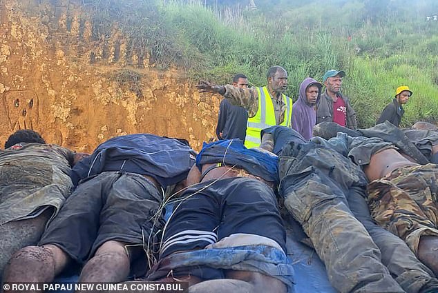 Dozens of men were recently shot dead in an ambush in Enga province, in the remote mountainous region of Papua New Guinea (authorities remove some of the bodies, pictured)