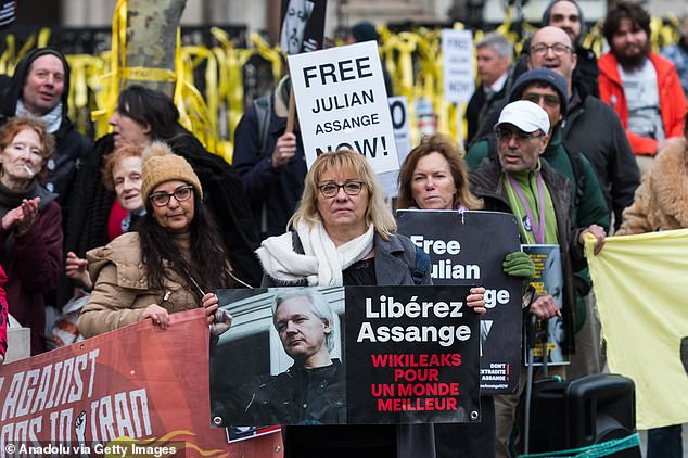 Supporters of Julian Assange demonstrate outside the Royal Courts of Justice on the first day of Assange's final appeal hearing.