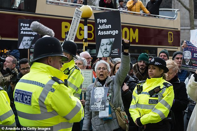 Police wait as protesters in London demand Assange's release