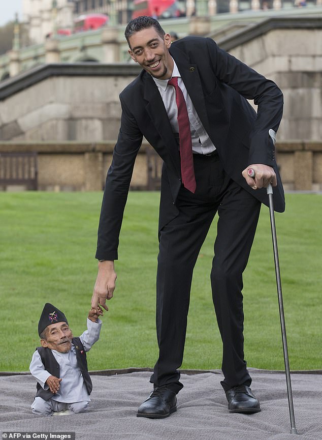 Chandra Bahadur Dangi of Nepal, left, the shortest adult ever verified by Guinness World Records, is pictured with the world's tallest man, Sultan Kosen of Turkey, in 2014.