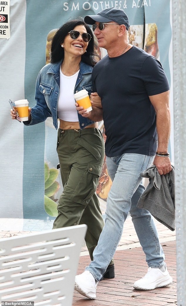 Sanchez showed off her midriff in a white crop top and army green cargo pants as she strolled arm in arm with Bezos, who celebrated his 60th birthday last month.
