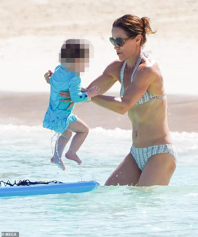 The hands-on mom wore minimal accessories for her family day, simply opting for a white watch that matched her bikini.