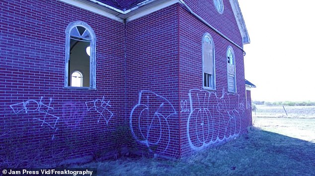 On one side of the abandoned church there were graffiti scrawls.