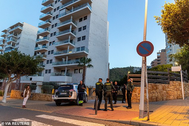 Agents of the Spanish Civil Guard stand in front of the garage where the body of Russian pilot Maksim Kuzminov was found after being shot dead.