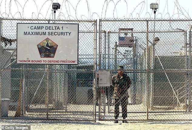 An Army soldier stands at the entrance to Camp Delta, where detainees from the U.S. war in Afghanistan live, April 7, 2004 in Guantanamo Bay, Cuba.