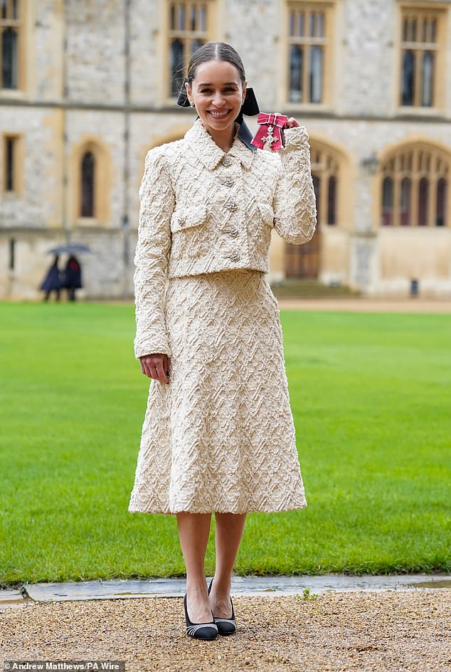 The Game of Thrones star, 37, smiled from ear to ear as she accepted her honors at Windsor Castle on Wednesday.