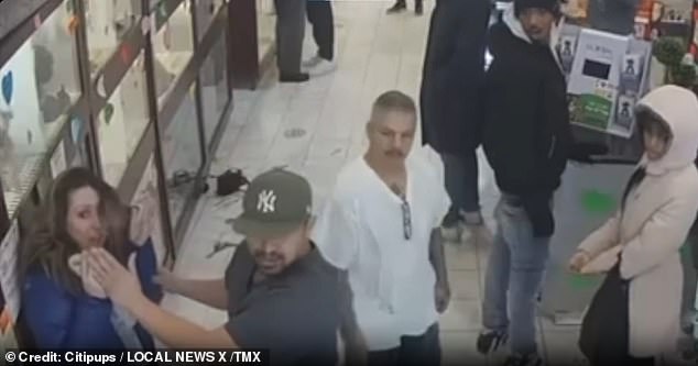 A man in the store could be seen comforting the slap victim and positioning himself as if to protect her from further potential attacks.