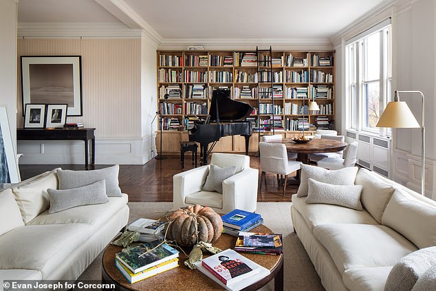 The photographer also added a bookcase wall to the 672-square-foot living room, complete with a sliding staircase.