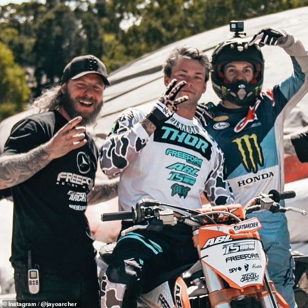 The 27-year-old (in the center of the photo with other motocross riders) was practicing the triple backflip trick that made him famous when he died.