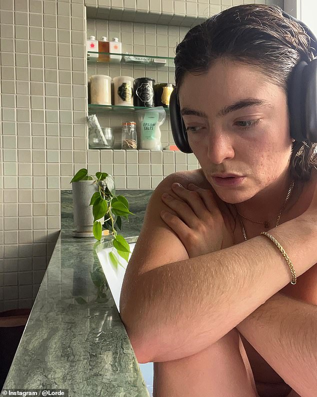 With her hair soaked, Lorde listened to music on a pair of black headphones and sported an array of gold jewelry.