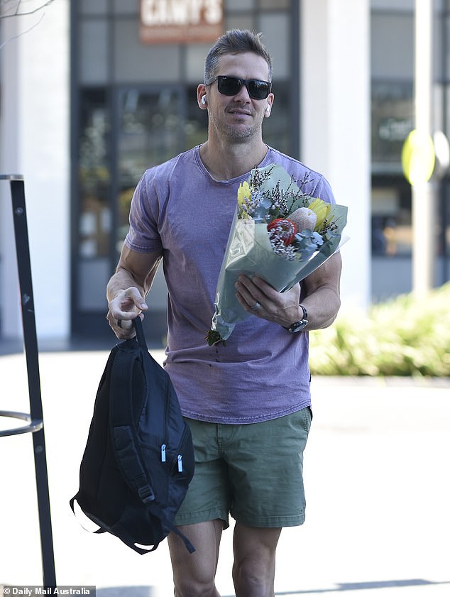 Photos taken by Daily Mail Australia on September 6 show Jono, 39, sporting a nervous smile as he returned to Skye Suites after stopping by a nearby florist to pick up a bouquet of colorful flowers for Lauren, 32.