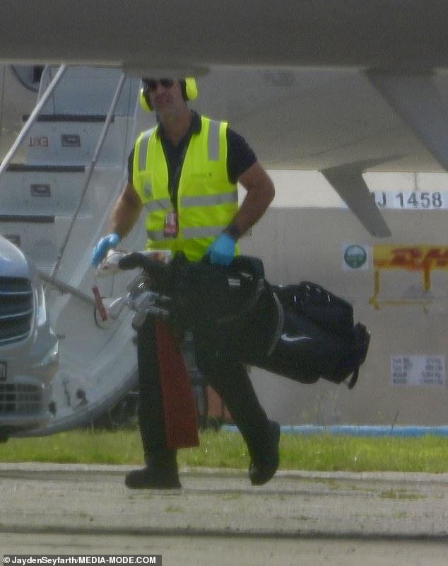 While disembarking from Taylor's private jet at Sydney Airport after landing at 8.57am, airport staff were seen removing their golf clubs from the Bombardier Global 6000.