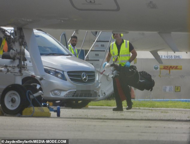 Staff were seen unloading the golf clubs from the plane and taking them to their chauffeur-driven vehicle.