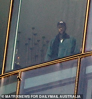 Travis Kelce was seen admiring the views from a luxurious hotel room in Sydney after landing in Australia on Thursday morning.
