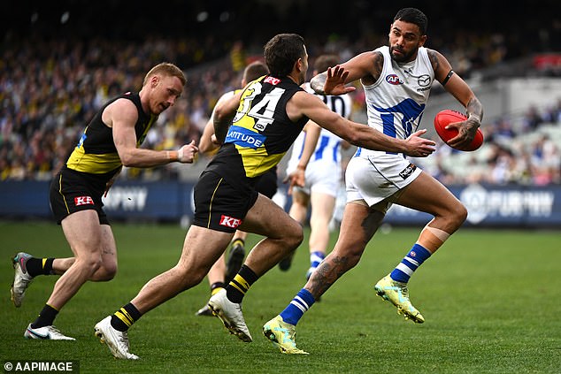 Thomas (pictured defending a tackler against Richmond last year) was sent to the VFL as a punishment during the 2023 season.