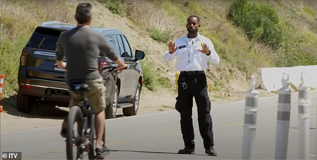 In a new clip, the pair follow Cowell as he leaves his Malibu home on a mountain bike before being stopped by two actors dressed as security guards.