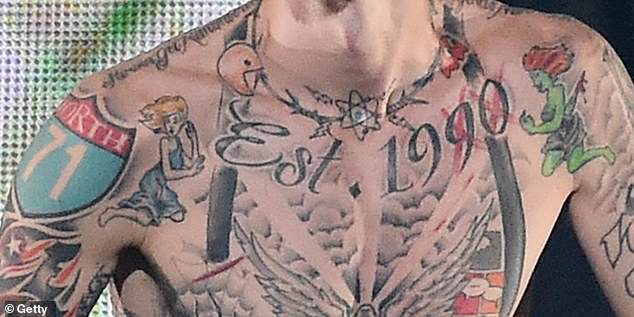 MGK has two tattoos of opposing female figures inked on either side of his shoulders.