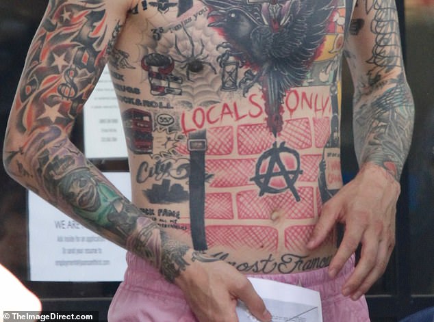 One of the few tattoos that are still visible on Kelly's now darkened upper torso is vibrant red. "LOCALS ONLY" phrase, which pays tribute to his upbringing in Cleveland