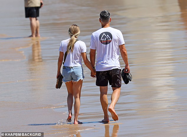 LeAnn held hands and stayed close to her handsome movie star husband Eddie, 50, who looked equally beach-ready in a white T-shirt and black shorts.