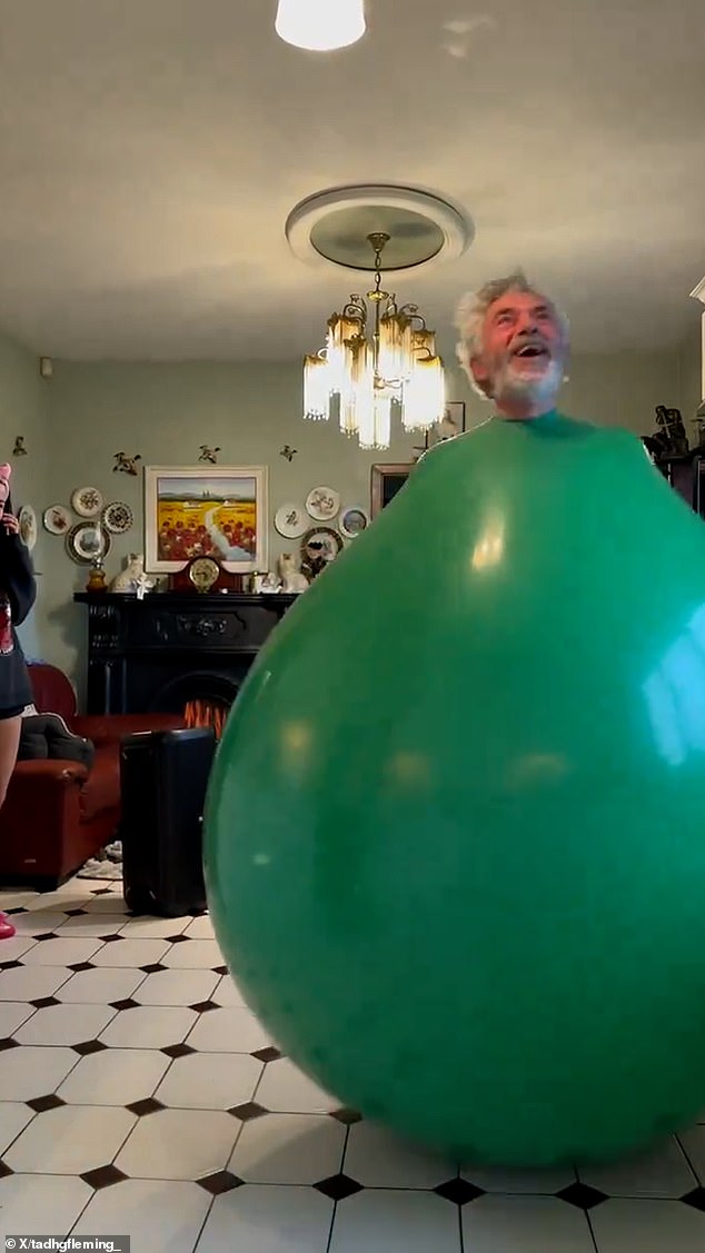 Tadgh's father is seen enjoying bouncing on the balloon to the music.