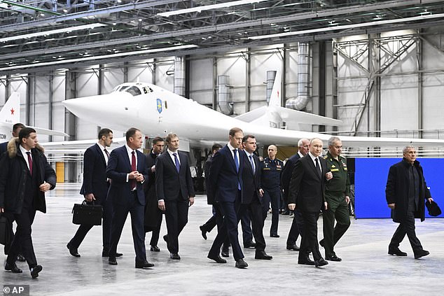 Putin (third from left) was seen on Wednesday giving a tour of the Kazan aviation factory, where several of the massive Tu-160M ​​bombers are located.