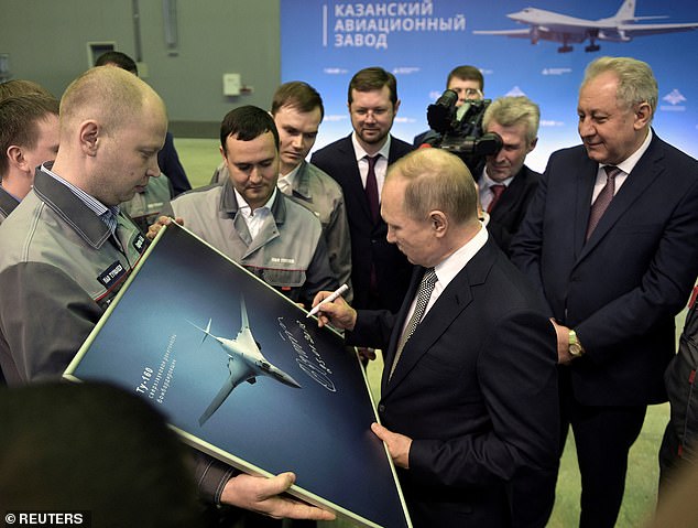 Putin signs a photograph of a TU-160M ​​nuclear bomber during a visit to the Gorbunov Aviation factory in Kazan, Russia, January 25, 2018 (file photo)