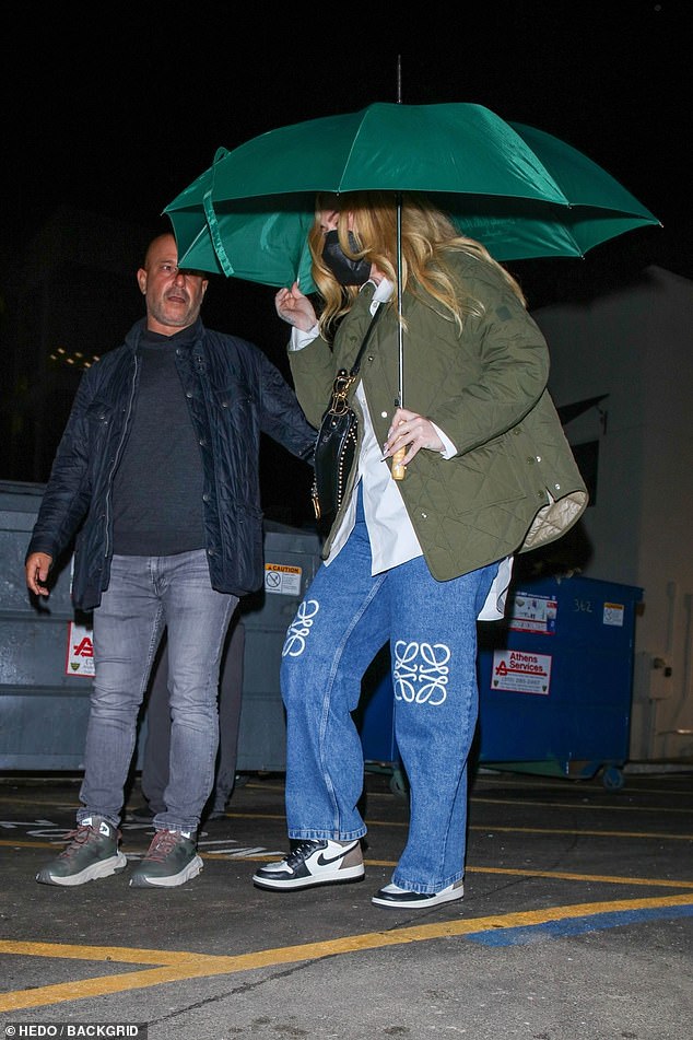 The singer cut a casual figure in a pair of £875 ($1,104) LOEWE Anagram jeans paired with a green quilted jacket and a Dior bag.