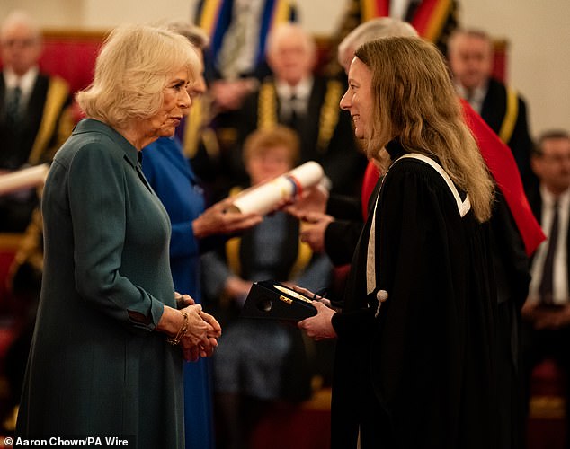 Queen Camilla presents the award to representatives of the University of Birmingham