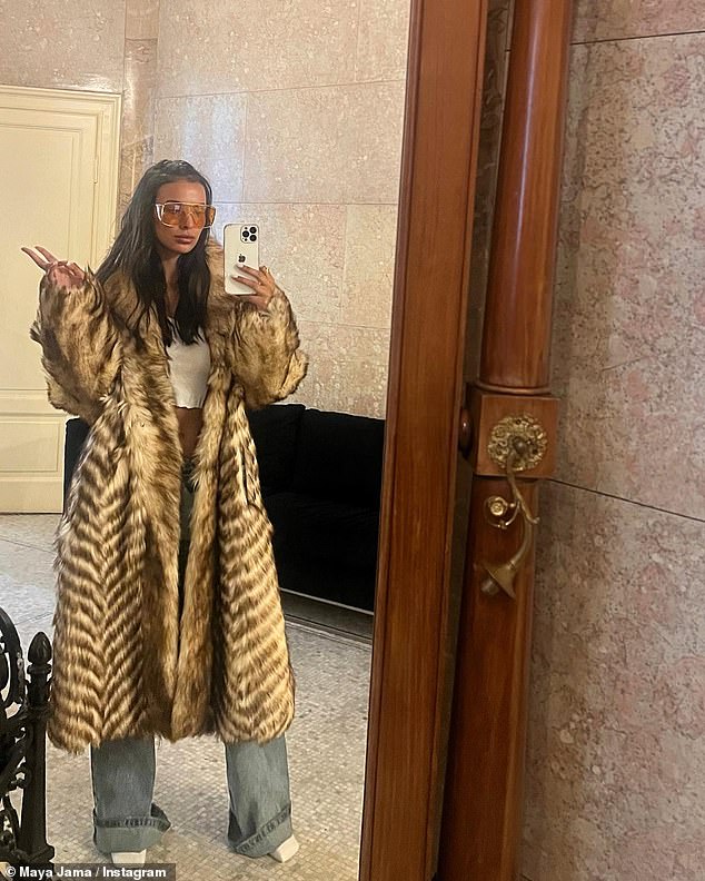 Maya later showed off another look, as she modeled a faux fur coat with a white crop top and a pair of wide-leg jeans and orange sunglasses.