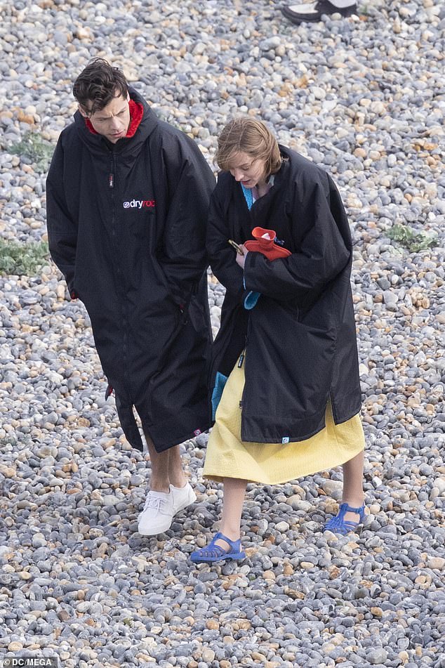 Harry Styles and Emma Corrin photographed on the set of The Policeman in 2021, and the actors appear to be wearing the garment for its intended purpose.