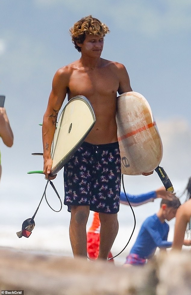 The singer frolicked on the beach with Armando Pérez, and the duo shared kisses and hugs, in photos obtained by The Sun (Armando pictured in June).