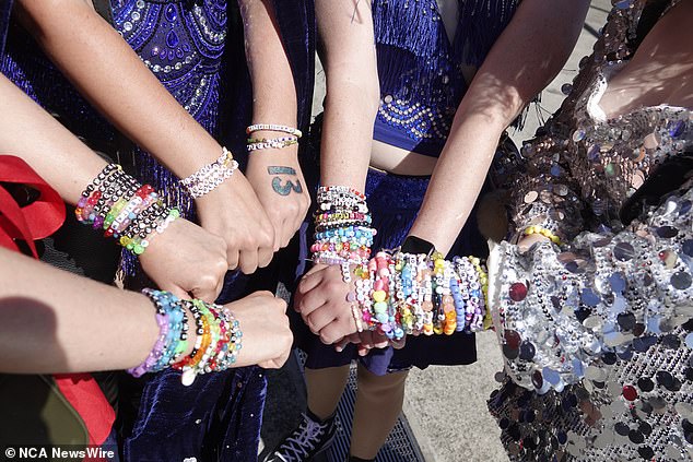 Taylor Swift fans pose with handmade bracelets before a concert in Melbourne
