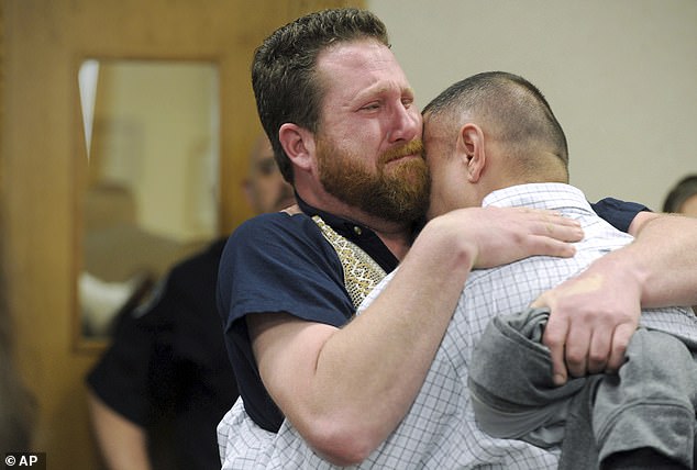 Christopher Tapp, right, and Jeremy Sargis, who was also originally linked to the crime but whose charges were dropped, hug during Tapp's post-conviction relief hearing at the Bonneville Courthouse in Idaho Falls, Idaho.