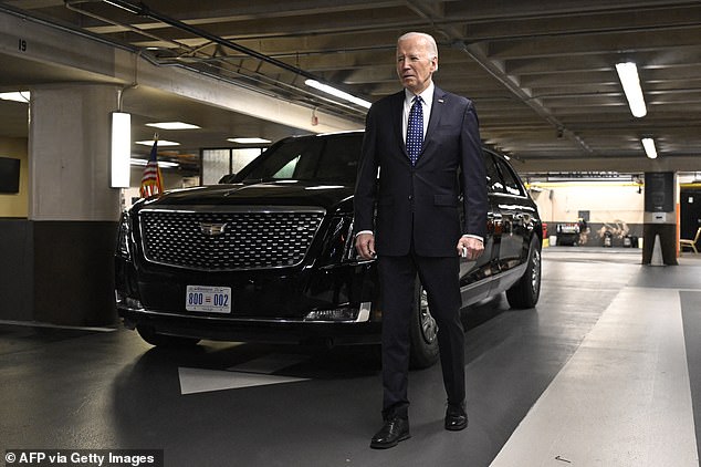 US President Joe Biden stands next to his vehicle 'The Beast' while speaking to the press in the parking lot of the Fairmont Hotel in Los Angeles, California, on February 22, 2024.