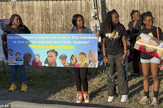 A group of protesters were seen holding signs with the teen's face outside Poole's home on Wednesday in support of George.
