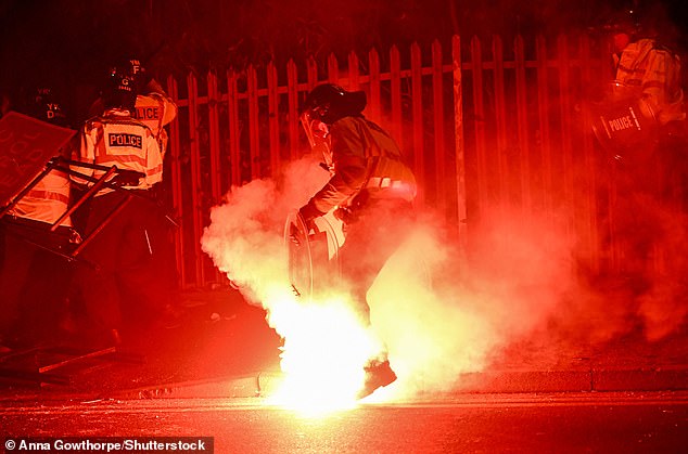 An officer was set on fire with a flare and five officers were injured before the Euro Cup qualifiers
