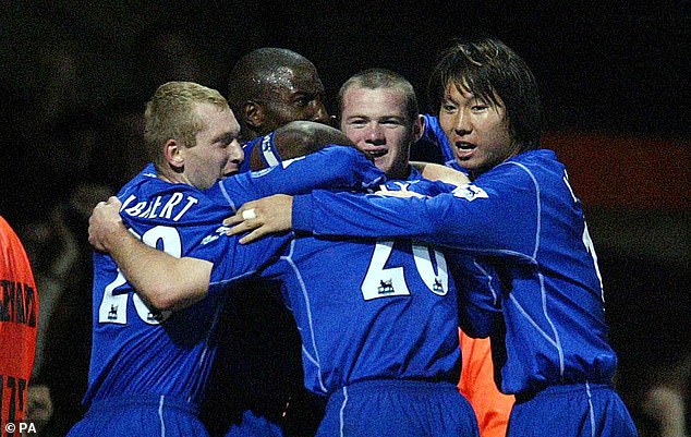 Li celebrates an Everton goal with Wayne Rooney during a Premiership match in 2002.