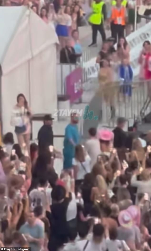 Travis was seen smiling while watching Taylor perform.