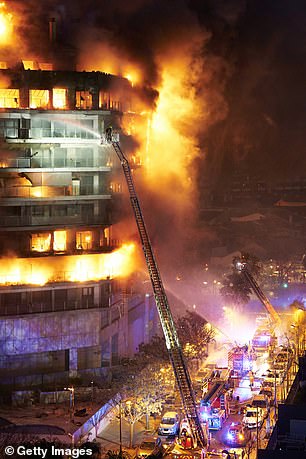 Firefighters work at the scene during the building fire on February 22, 2024.