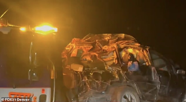 The wrecked vehicle is also shown being towed on the back of a truck.