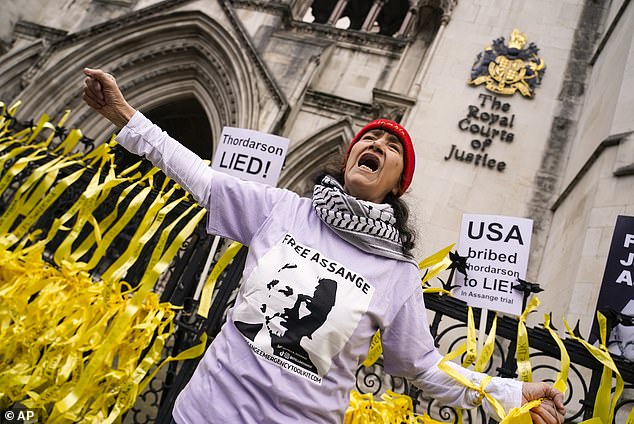 Court hearings this week will determine whether Assange will be extradited to the United States. A protester shouts slogans outside the Royal Courts of Justice in London on Tuesday.