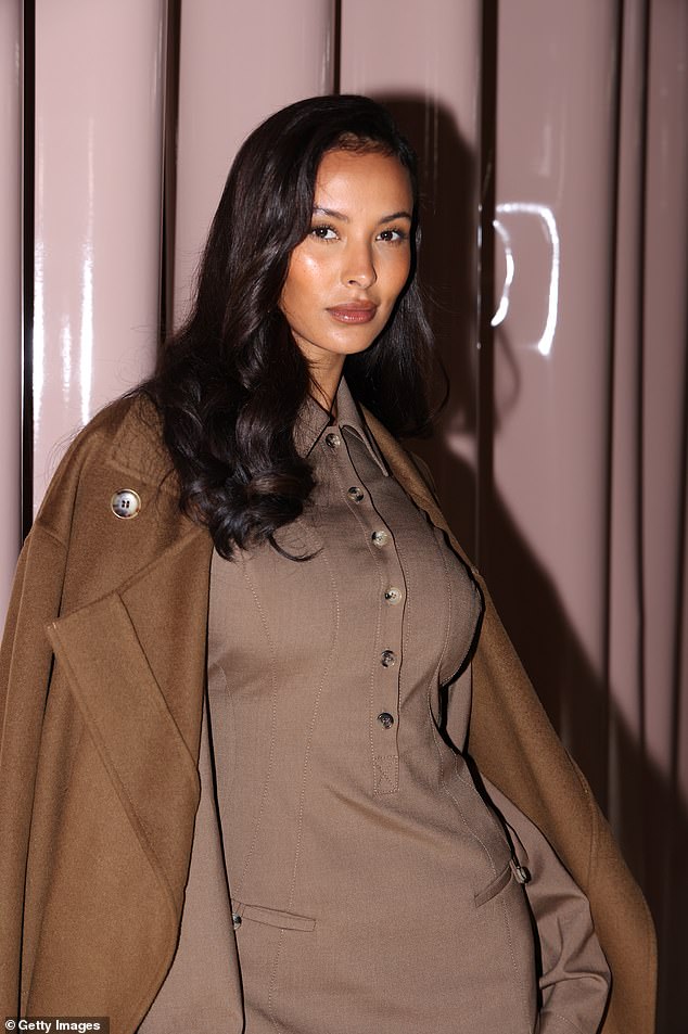 She paired her button-down number with a floor-length dark brown trench coat, which she threw casually over her shoulders.