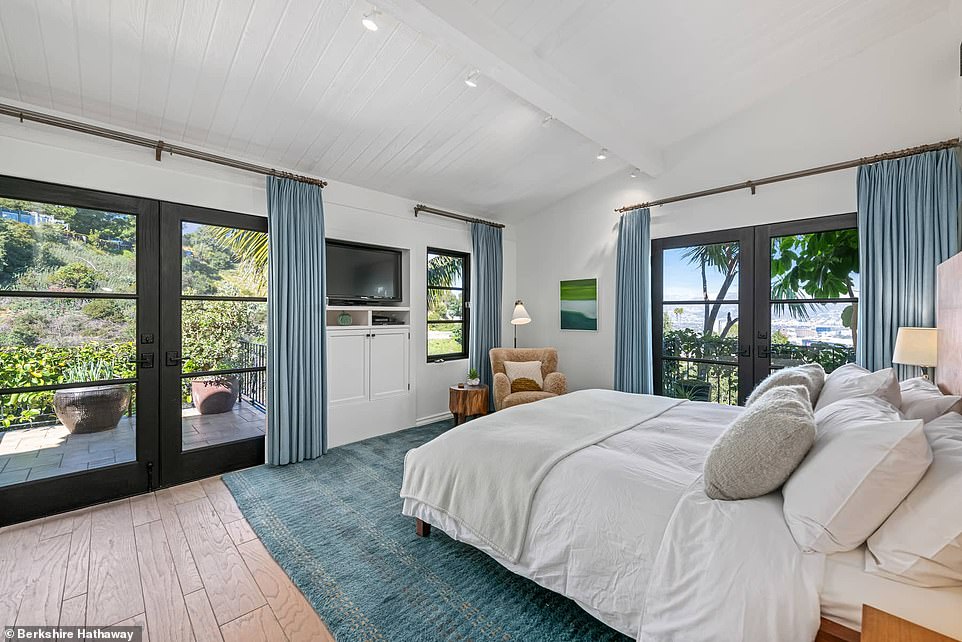 The master bedroom, conveniently located on the main level, offers a private terrace.