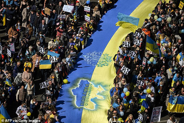 A giant Ukrainian flag flew during a protest against the Russian invasion of Ukraine in Madrid, Spain, one of the 31 members of NATO.