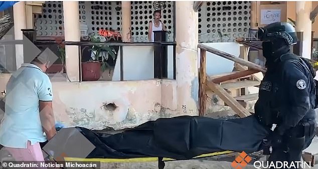 Acapulco police remove one of two bodies found dead inside a cabin on Playa Condesa in Acapulco, Mexico, on Thursday. The city reported 31 murders in
